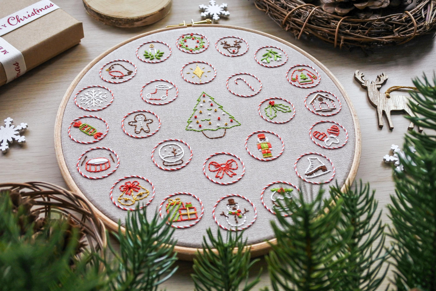 Angled closeup of the hand-embroidered Christmas advent calendar design.