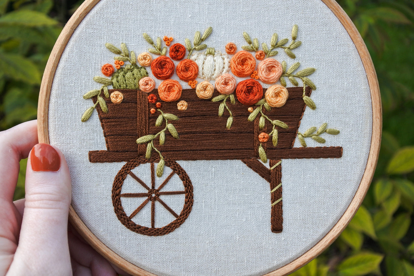 hand holding the autumn wagon hand embroidery hoop art