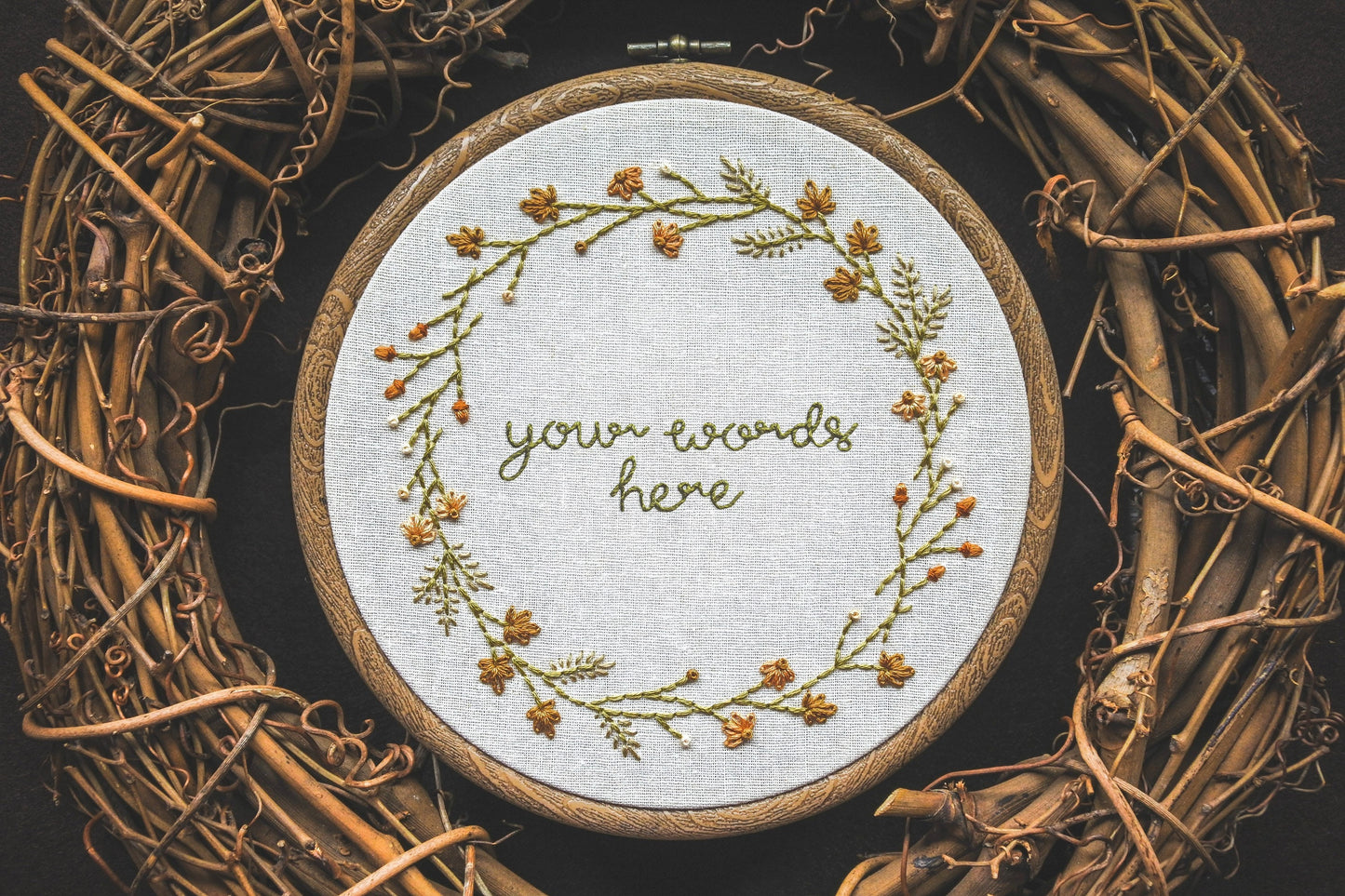 Custom autumn wreath embroidery hoop with 'your words here' lettering in the centre, surrounded by leaves, grasses, coneflowers, and acorns