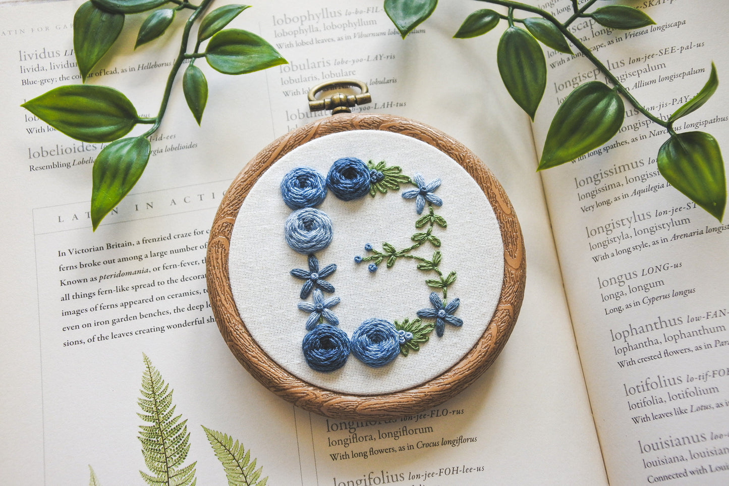 Blue floral letter 'B' embroidery hoop, highlighting the hand stitched flowers and detailing.