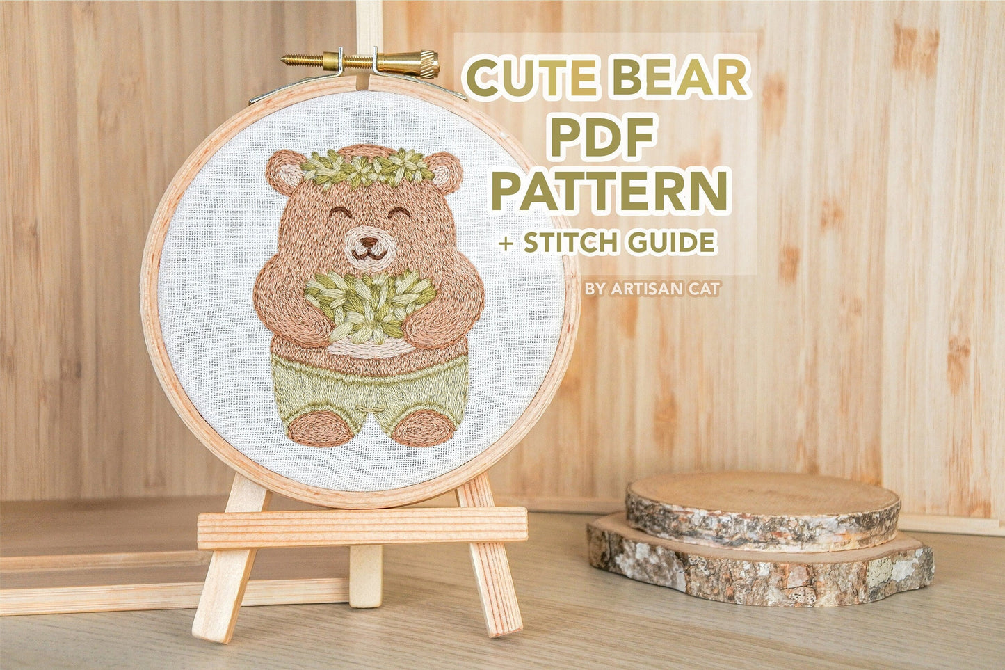 Hand-embroidered bear hoop on a mini wooden easel, with text overlay that reads “cute bear PDF pattern and stitch guide by artisan cat”