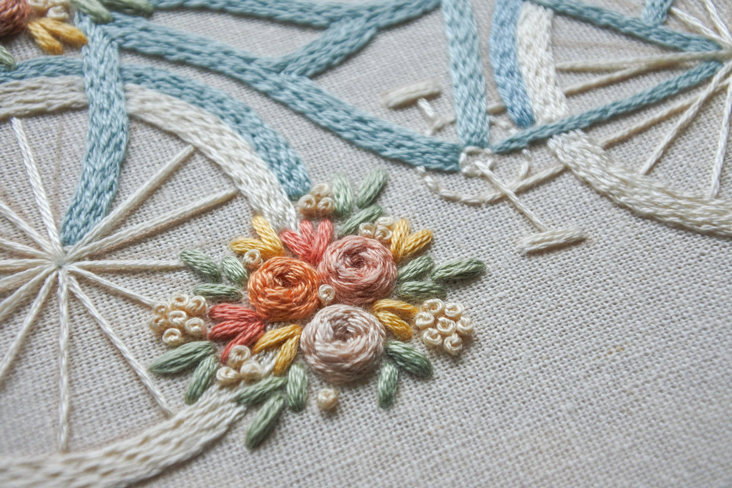 Close-up of one of the colourful floral bouquets in the floral bicycle embroidery design.