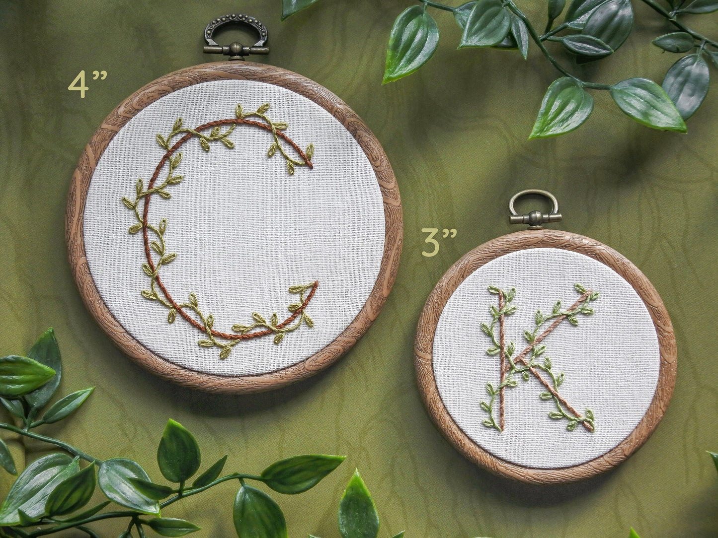 Side-by-side comparison of 4-inch and 3-inch embroidery hoops showing letter C and letter K each with leafy vine details