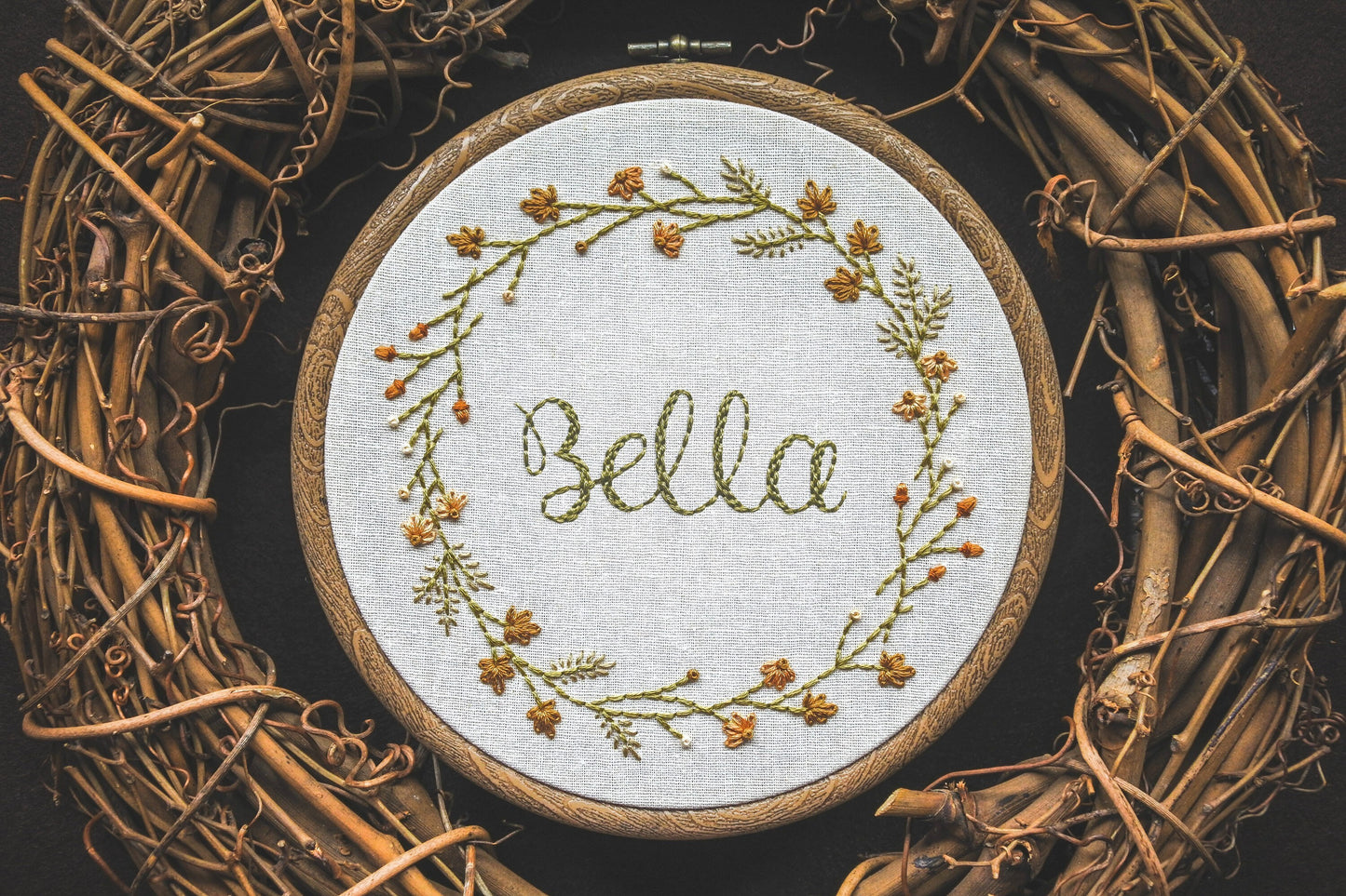 Hand-embroidered autumn wreath with personalised lettering ‘Bella’ in the centre