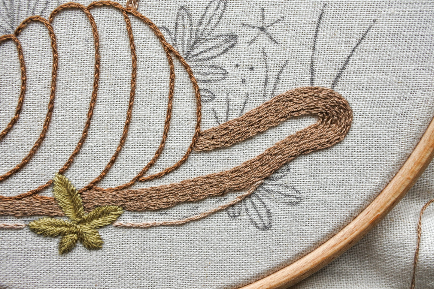 Work in progress shot of embroidering the snail with split stitch