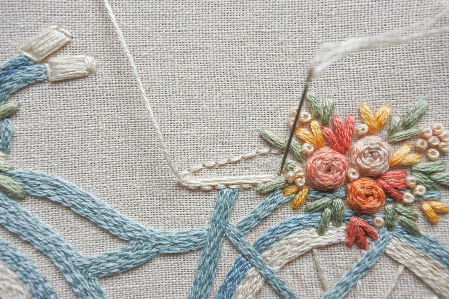 Close-up of stitching the bicycle seat on the floral bike design.