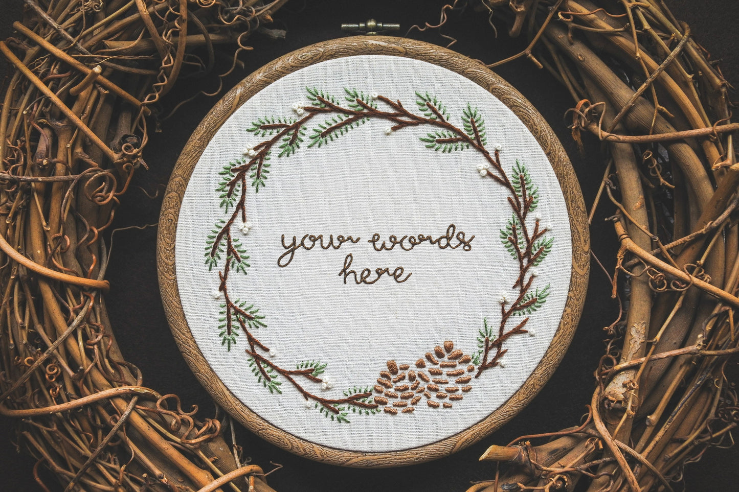 Winter wreath embroidery hoop with placeholder text 'your words here' in the centre.