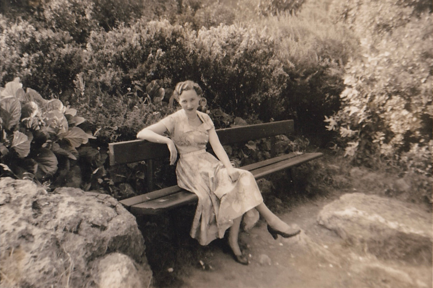 Old scanned photo of Catherine’s Nan in a beautiful dress, smiling at the camera.
