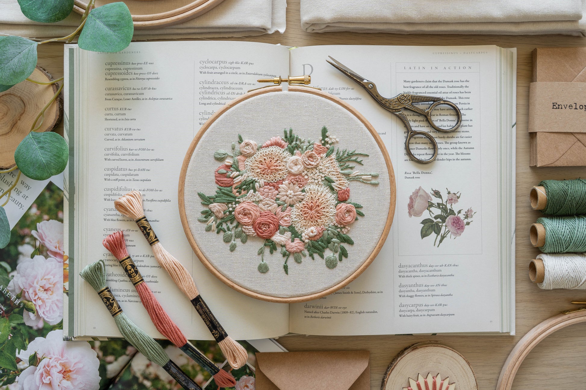 Hand-embroidered floral bouquet hoop with cream dahlias, soft pink and cream roses and eucalyptus greenery