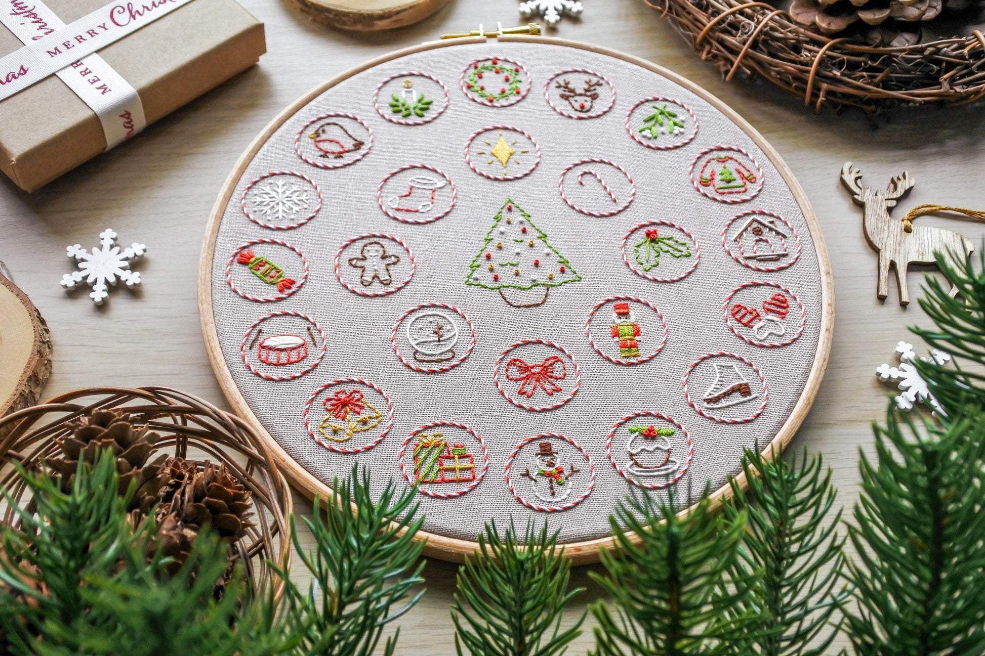 Slight angle of the full hand-embroidered Advent Calendar design, showcasing festive elements stitched.