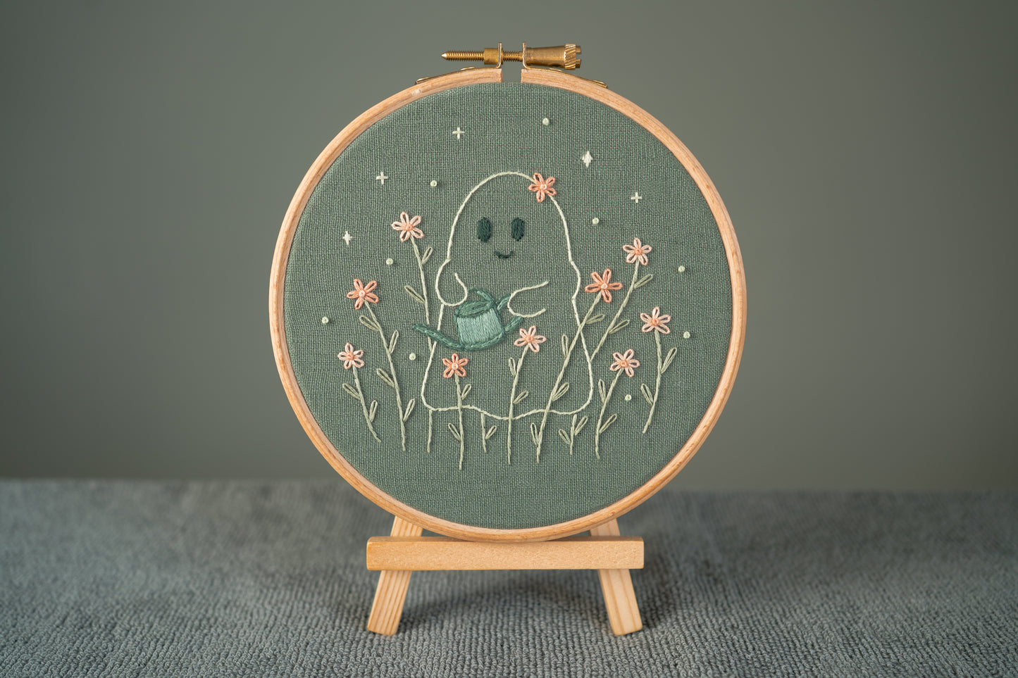 ghost gardener embroidery hoop displayed on a mini easel
