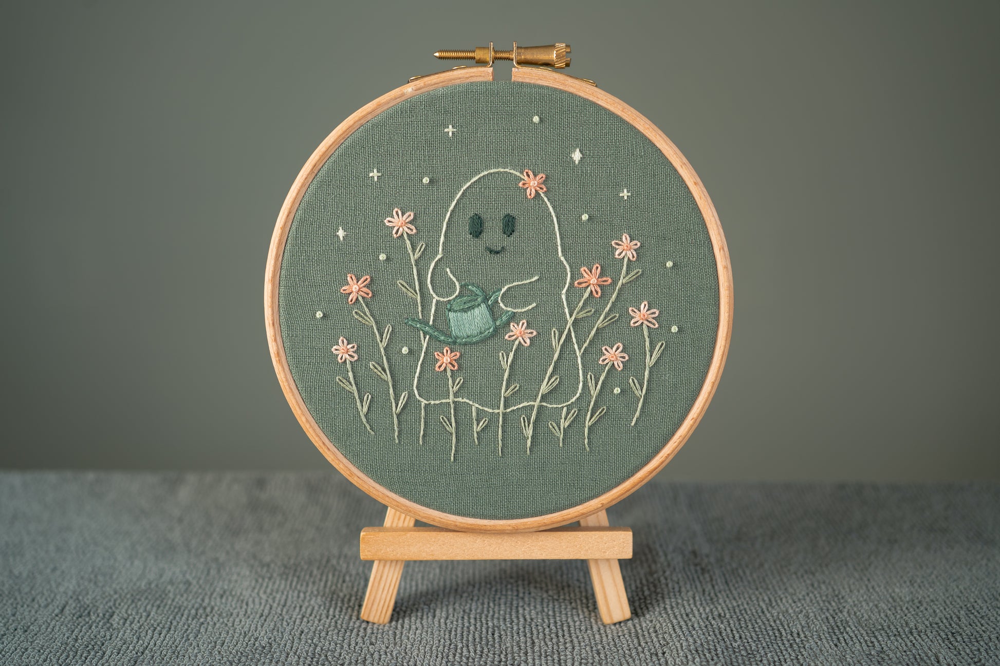 ghost gardener embroidery hoop displayed on a mini easel