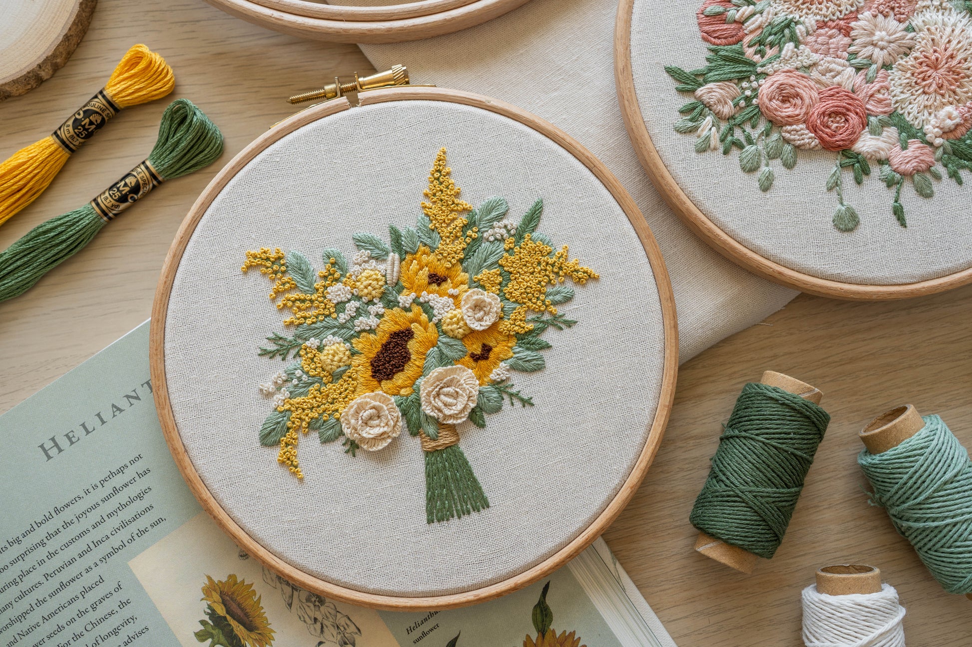 Hand stitched custom floral embroidery hoop, featuring a beautiful bouquet of sunflowers and roses with eucalyptus foliage