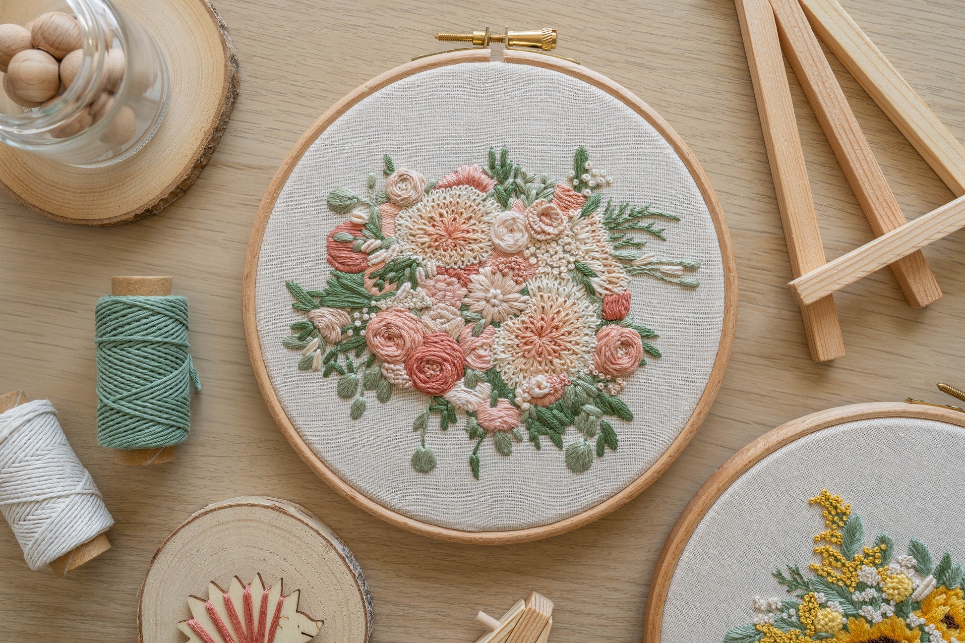 Custom hand embroidered floral bouquet keepsake in a wooden hoop frame, featuring cream dahlias, soft pink roses and eucalyptus green foliage