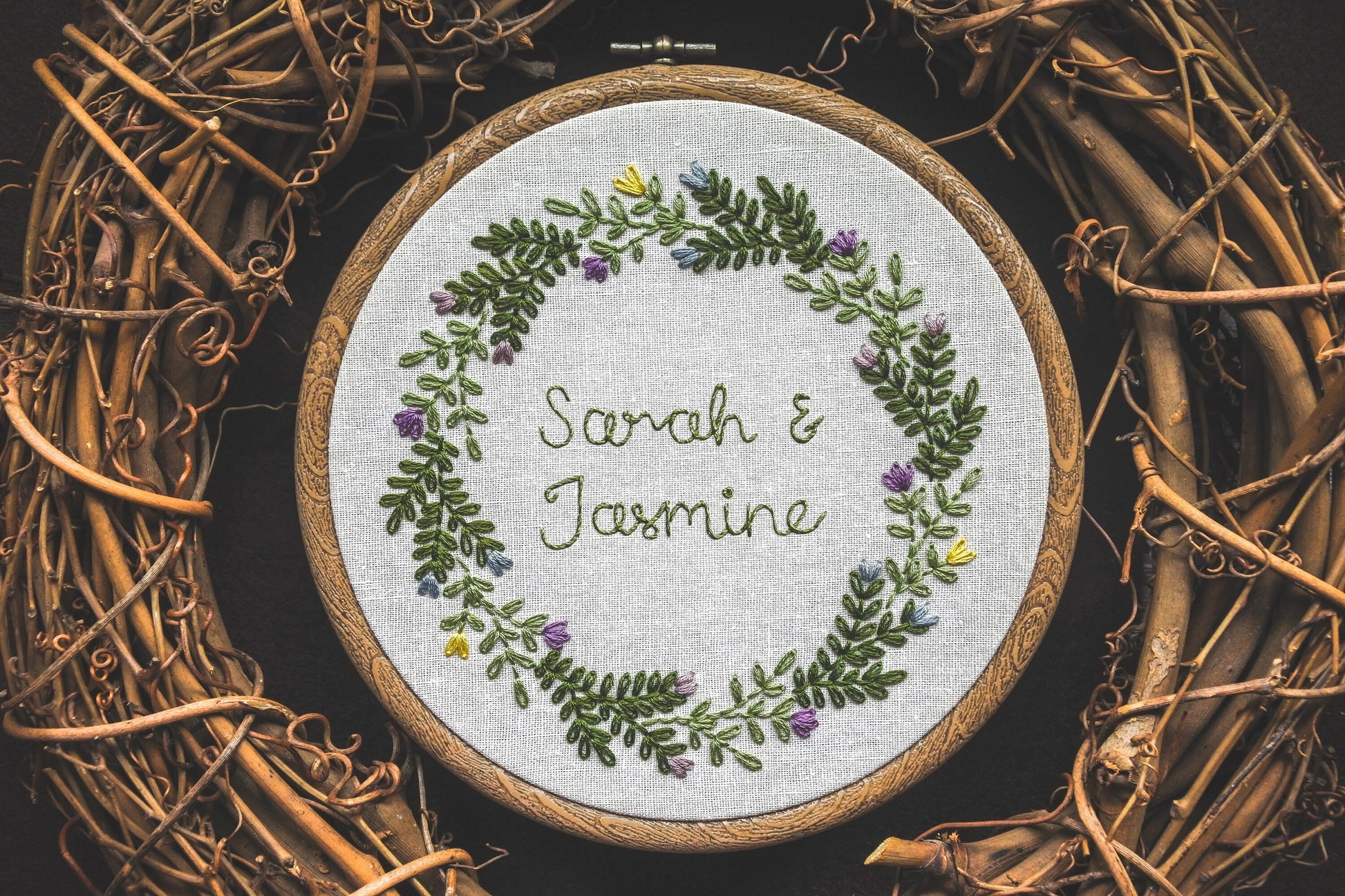 Spring wedding embroidery hoop with the names Sarah and Jasmine stitched in the centre