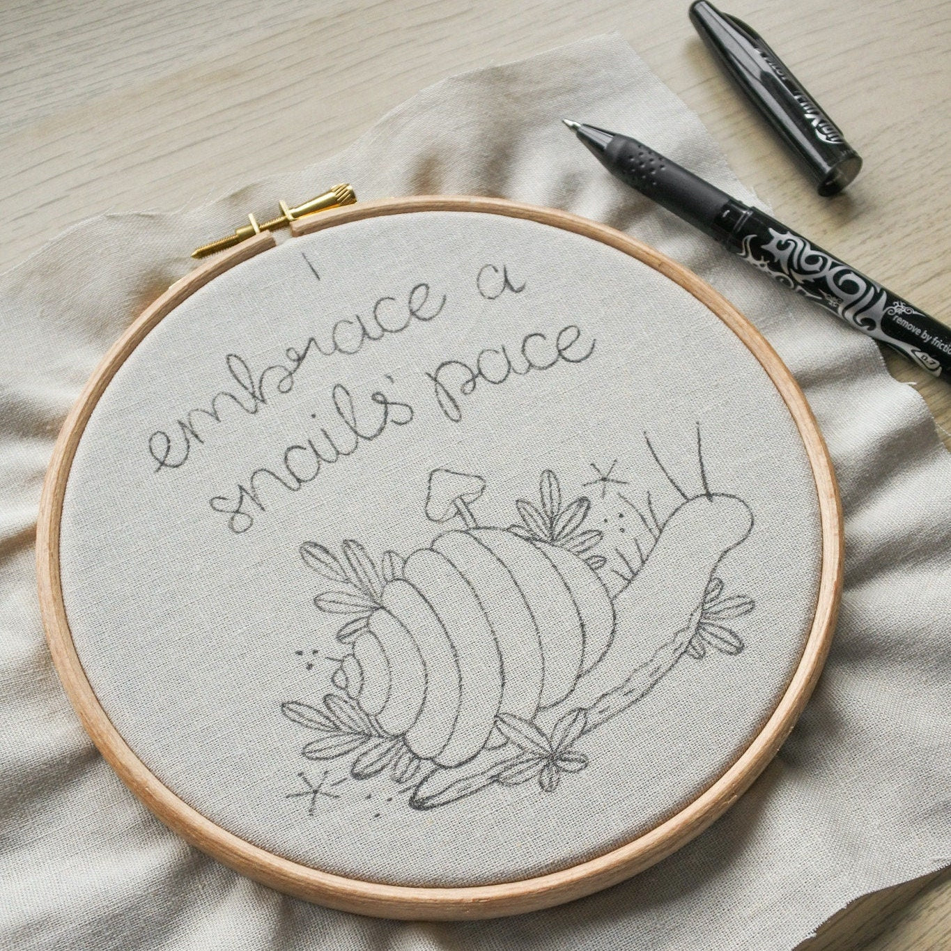 Snail design drawn on fabric with heat erasable black pen