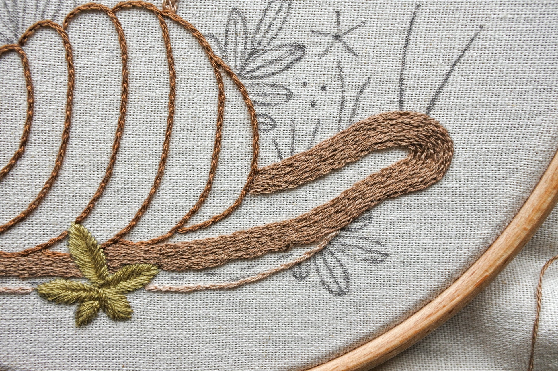 Work in progress shot of embroidering the snail with split stitch