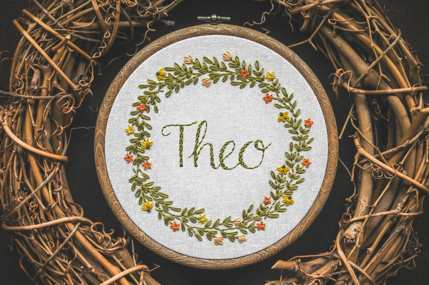 Custom summer wreath design with the name "Theo" hand embroidered in the centre.